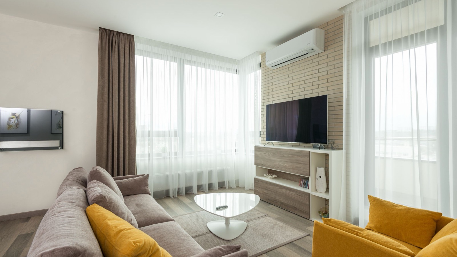Wall mounted ductless mini split head in a bright living room, the kind of single zone install a pre charged quick connect line set makes possible in a day