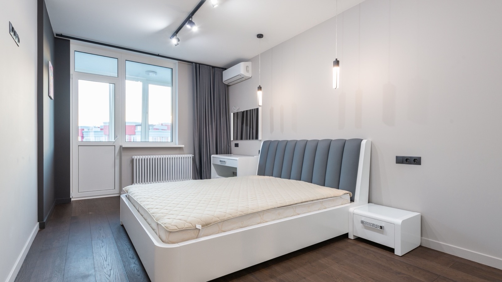 Top rated DIY ductless mini split: white wall-mounted indoor unit above the window in a modern bedroom